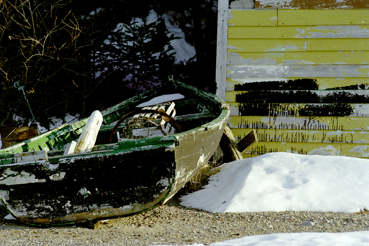 Vintage Wooden Boat: Paint, Tar, and Nostalgia in Receding Snow